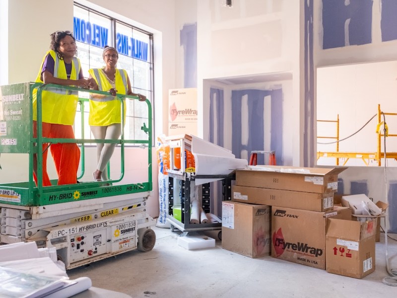 Jaren Hill Lockridge and Nardos Alemayehu of Dreaming Out Loud survey the construction inside the upcoming Marion Barry Avenue Market. (Ja'Mon Jackson/The Washington Informer)