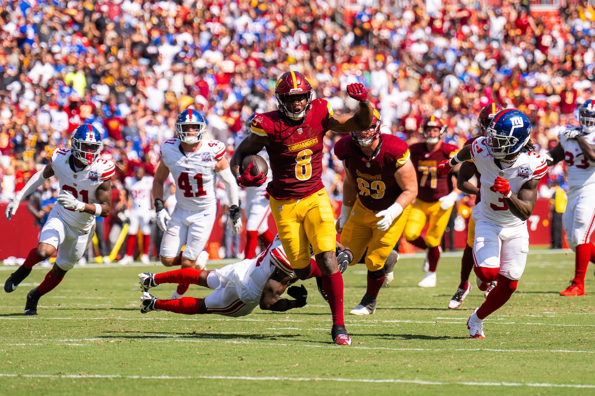 Commanders running back Brian Robinson Jr. advancing in rushing yards striking past the Giants defense. (Abdullah Konte/The Washington Informer)