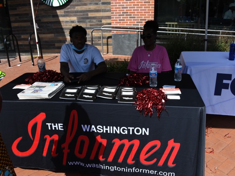 **FILE** Washington Informer Office and Circulation Manager Angie Johnson (right) and her grandson James Johnson (left) at a community event. August is National Black Business Month, celebrating the contributions of Black businesses, such as The Washington Informer, which is Black and woman-owned. During the month patrons are encouraged to support Black-owned establishments. (WI photo)