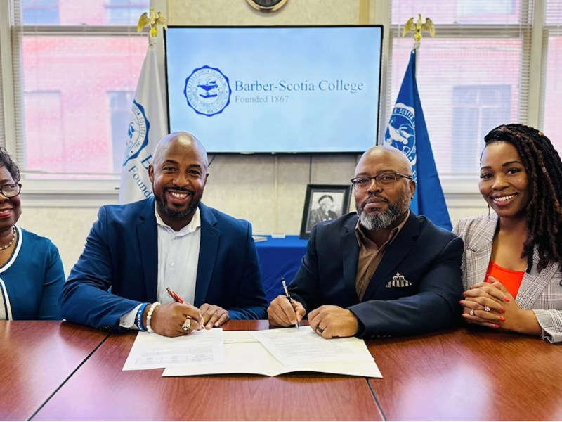 From left: Roberta H. Pinckney, chair of the Barber-Scotia College Board of Trustees, and Chris Rey, president of Barber-Scotia meet with Skilldora co-founders, CEO DeMario Mcllwain and COO Dawn Mcllwain, to officiate the institution’s partnership with the HBCU initiative. (Courtesy of Barber-Scotia College)