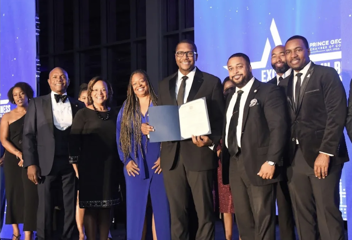 **FILE** During the 2023 Excellence in Business Awards, Prince George’s Chamber of Commerce President Alexander Austin (center) holds a state proclamation, presented for the organization’s achievements and role in empowering the local economy. (Anthony Tilghman/The Washington Informer)