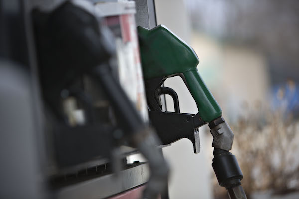 **FILE** Filler hoses sit outside a gas station in Creve Coeur, Illinois, U.S., on Friday, Dec. 11, 2015. (Daniel Acker/Bloomberg via Getty Images)