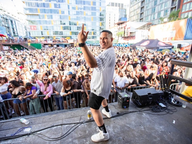 DJ Pedro Night commands the stage with infectious energy, transforming the urban landscape into a vibrant festival of music and unity. (Courtesy of ShotbyBlanco)