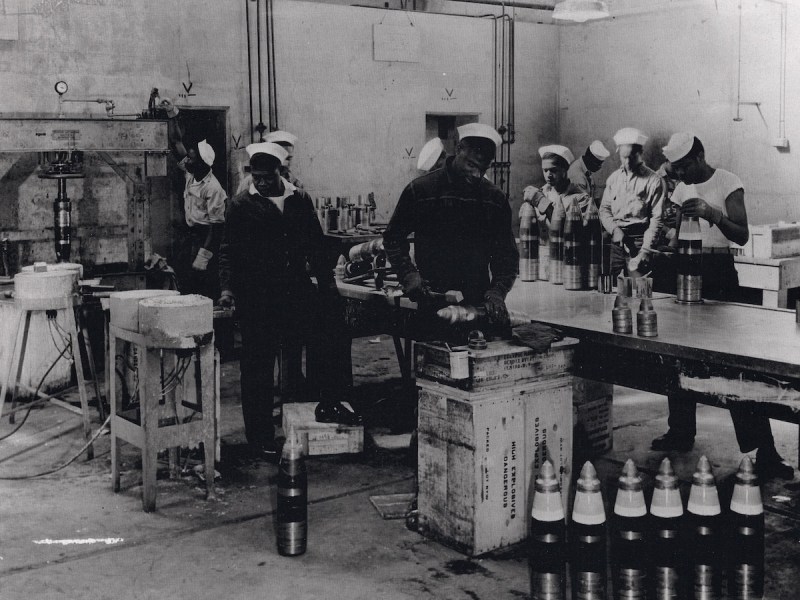 **FILE** African American sailors of an ordnance battalion prepare 5-inch shells for packing at the Port Chicago Naval Magazine in 1943. (U.S. Navy via Wikimedia Commons)