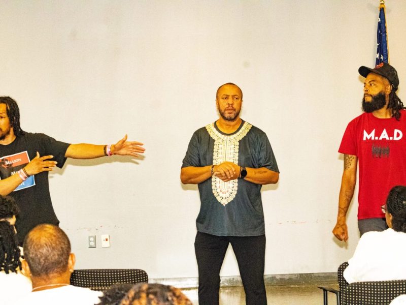 Chris Thomas from Million Man Vote, Ambrose Lane Jr. (Health Alliance Network), and Prince Hamm from Making A Difference (M.A.D.) speak to students attending the International Overdose Awareness Day event. (Cleveland Nelson/The Washington Informer)