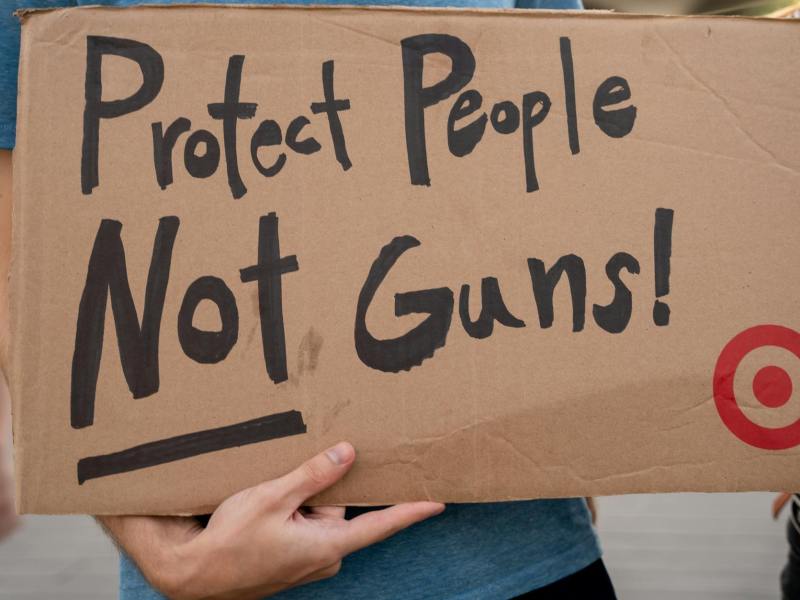 close up of person holding a sign at a protest against gun violence