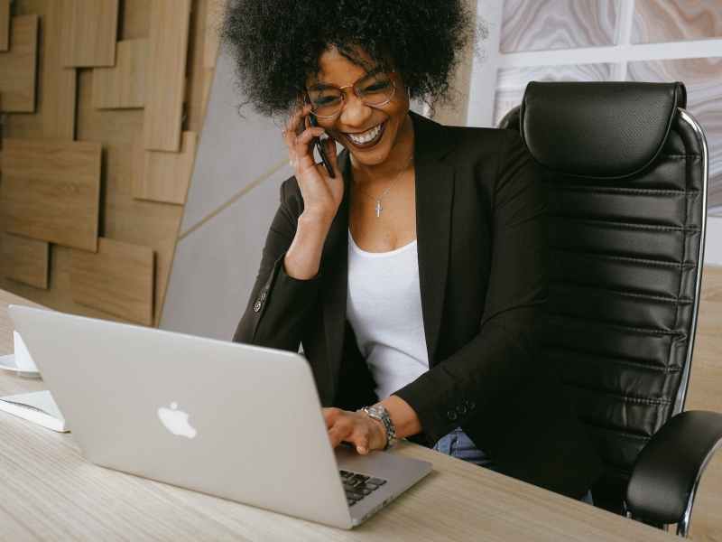 woman in black blazer sitting on black office chair