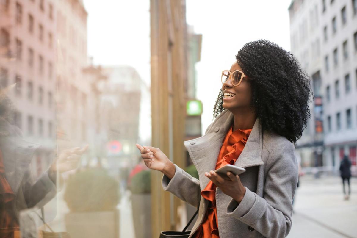 happy black woman laughing on street