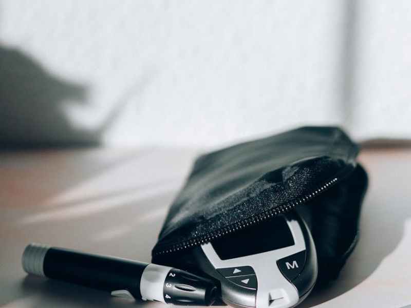 black and white click pen beside black leather pouch